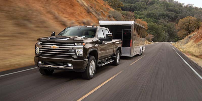 2023 Chevrolet Silverado 2500 hauling a trailer on the road - Gunn Chevrolet in Selma TX
