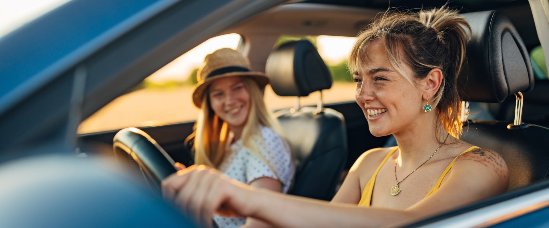 Two girls driving their used vehicle